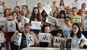 Students after the calligraphy workshop with their names written in Chinese
